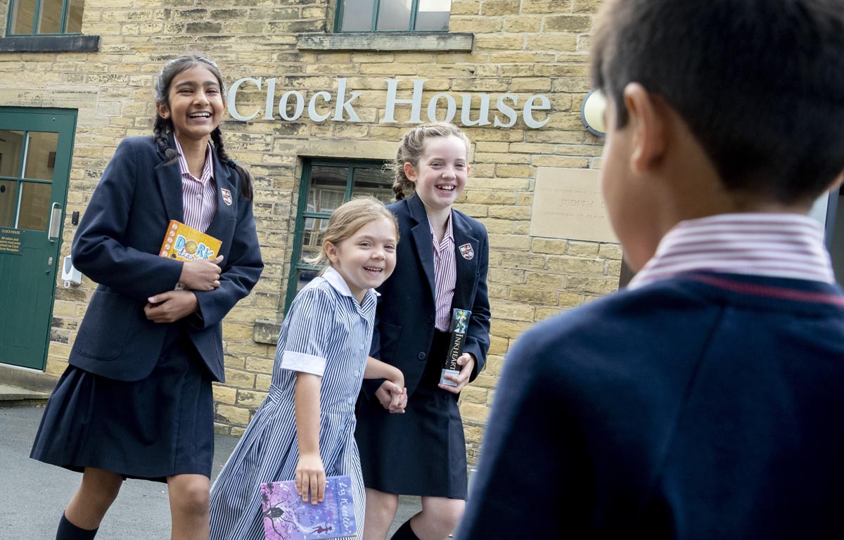 Image of Bradford Grammar Junior School pupils smiling in the playground