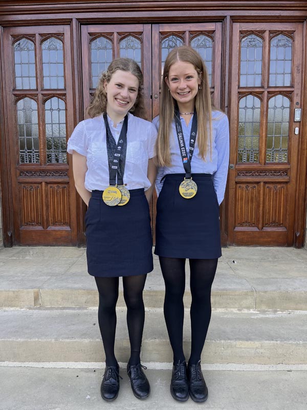 Rebecca and Amelie wearing their medals after clinching gold in the Under 20 Women’s race at the World Mountain and Trail Running Championships (WMTRC) in Innsbruck, Austria.