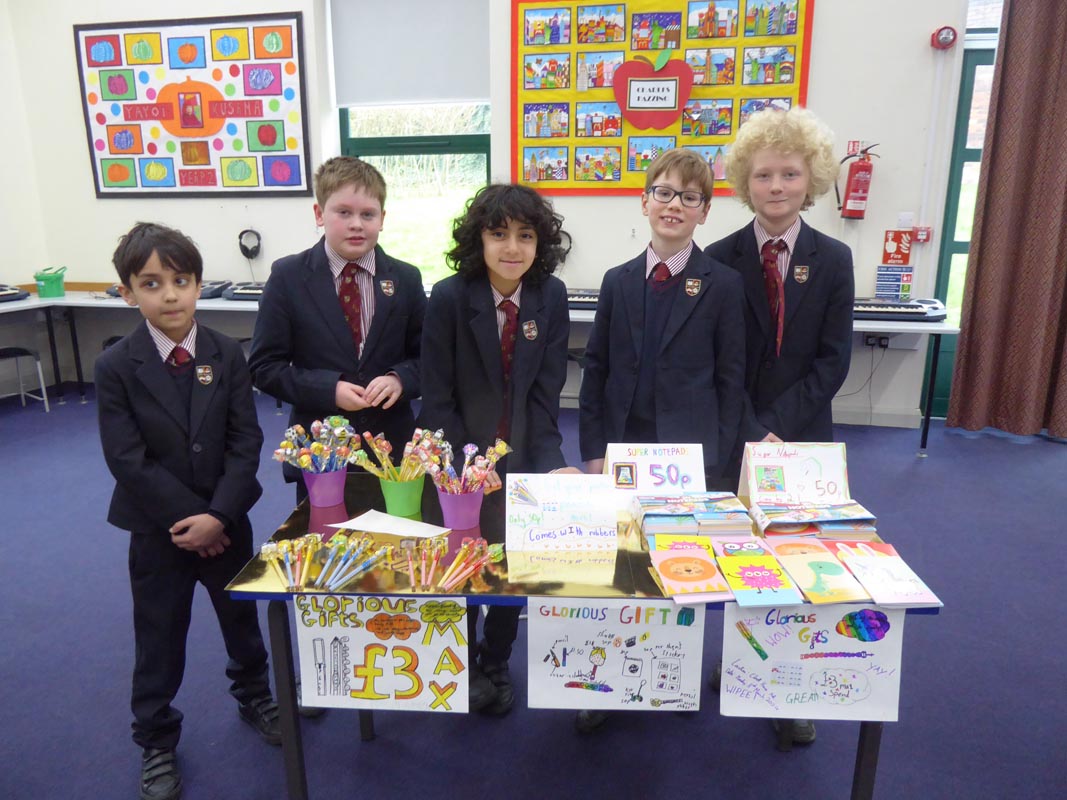 Five Junior School pupils selling stationery at a stall