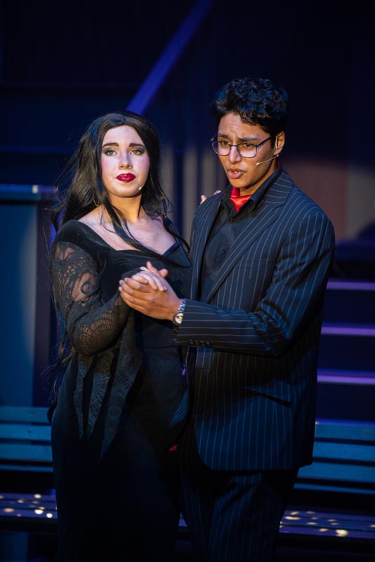 Two drama students standing together in black clothing