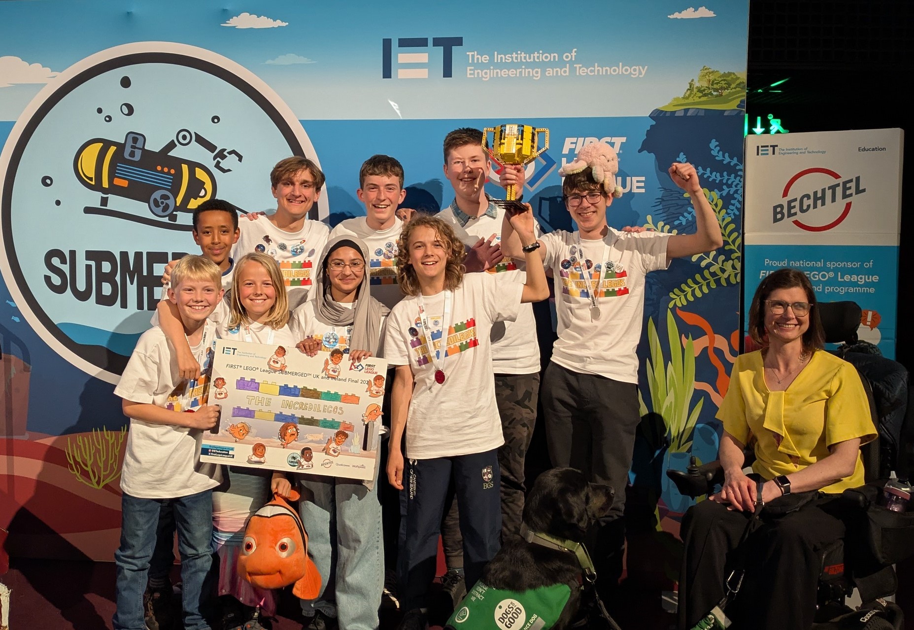 The BGS Incredilegos in their team t-shirts celebrating with the trophy