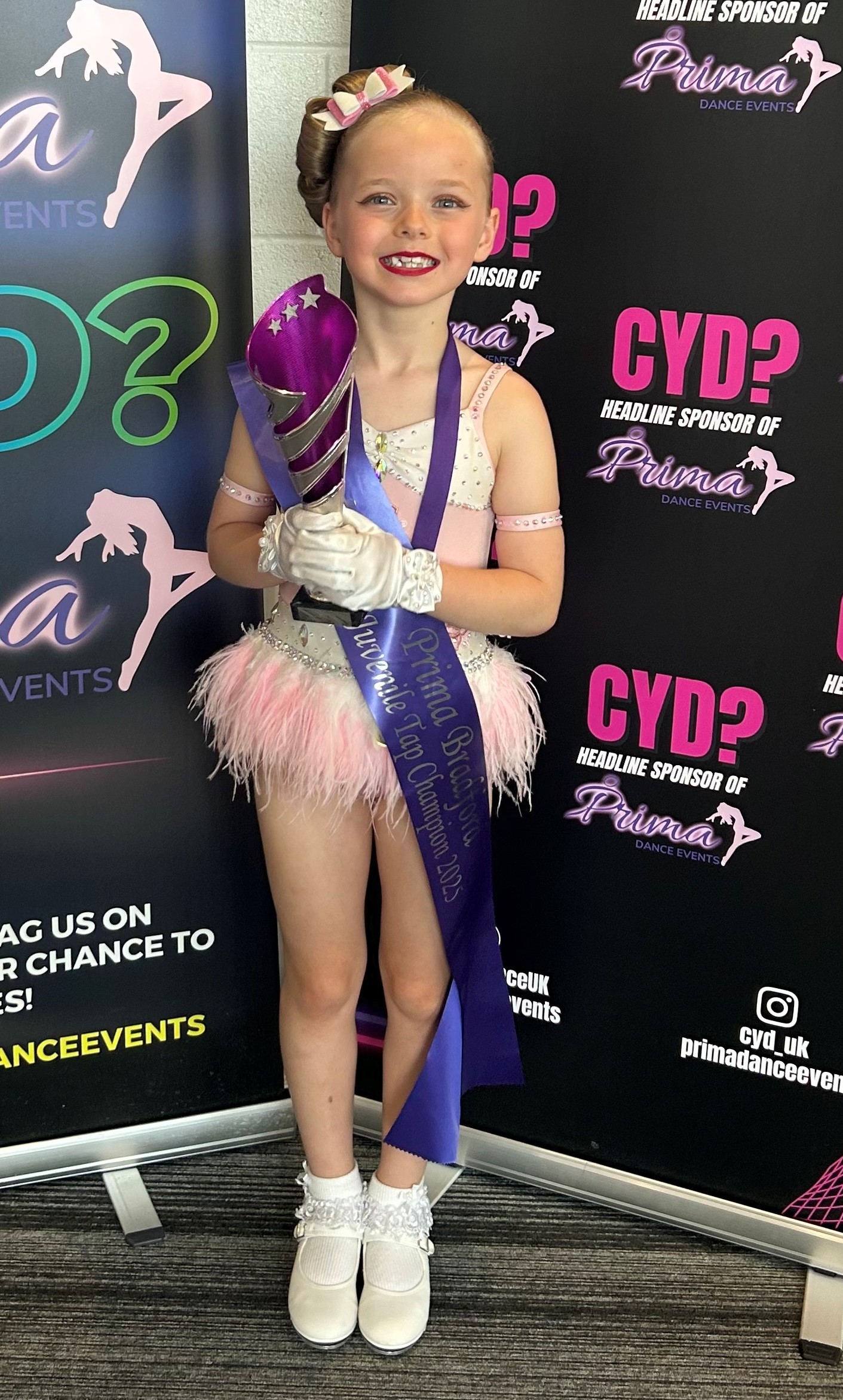 Sophie in here tap costume the her winners sash and trophy