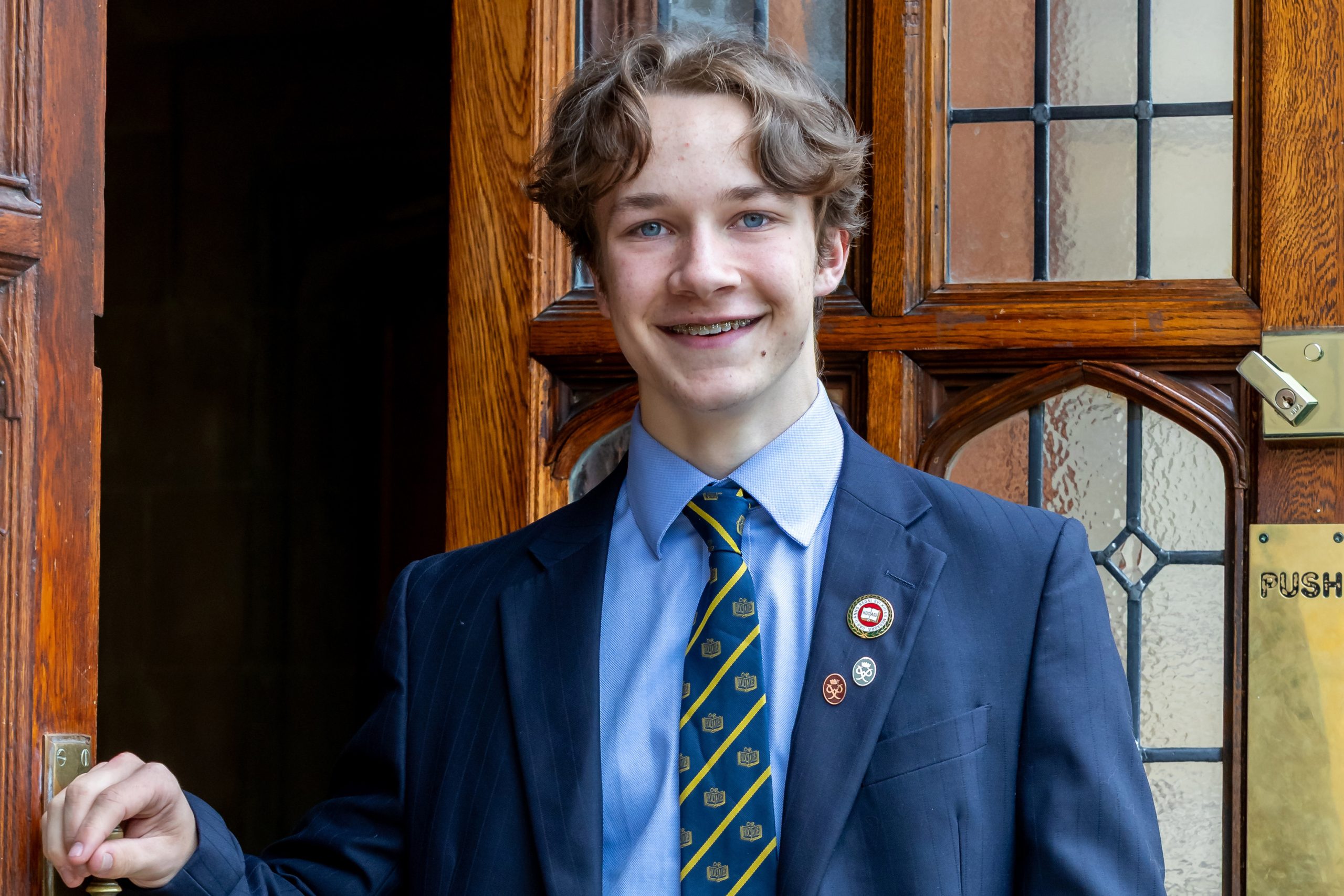 Head Boy Leo MG Leo stood smiling by main school reception